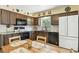 Charming kitchen features granite counters, decoratively-tiled backsplash, and modern appliances at 452 Gordon Dr, Castle Rock, CO 80104