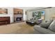 Inviting living room boasts a cozy fireplace, large windows, and comfortable seating at 452 Gordon Dr, Castle Rock, CO 80104