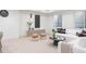 Comfortable basement area with modern decor, featuring a plush sofa and stylish round ottomans at 716 S Race St, Denver, CO 80209