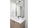 Sleek bathroom boasts a modern vanity with wood accents and a white countertop basin at 716 S Race St, Denver, CO 80209
