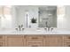 Bright bathroom featuring double vanity with quartz countertop, sleek faucets, and a glass-enclosed shower at 716 S Race St, Denver, CO 80209