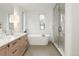 Modern bathroom with dual vanity, soaking tub, glass shower, and neutral finishes for a spa-like feel at 716 S Race St, Denver, CO 80209