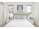 Well lit bedroom boasts white walls, a gray upholstered bed and an ocean themed art piece above the headboard at 716 S Race St, Denver, CO 80209