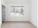 Empty bedroom boasts neutral carpet, base trim and walls, and a large window with views at 716 S Race St, Denver, CO 80209