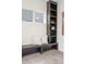 Modern entryway with sleek black bench, built-in shelving, neutral pillows and attractive tiled flooring at 716 S Race St, Denver, CO 80209