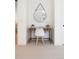 Small home office nook with a simple desk, modern chair, round mirror, and neutral carpet at 716 S Race St, Denver, CO 80209