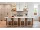 Bright kitchen features a large island with bar seating, modern appliances, and stylish pendant lighting at 716 S Race St, Denver, CO 80209