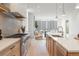 A bright, open kitchen with stainless steel appliances and a view into the living space beyond at 716 S Race St, Denver, CO 80209