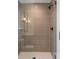 Luxurious shower with modern bronze fixtures, decorative tile, clear glass enclosure, and a built in niche at 716 S Race St, Denver, CO 80209