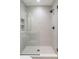 Modern walk-in shower features gray tiling, a rainfall shower head, and a built-in shelf at 716 S Race St, Denver, CO 80209