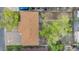 Aerial view of brick house, with brown roof, big backyard tree, and a blue sedan parked on the street at 258 S 14Th Ave, Brighton, CO 80601