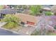 Aerial view of house with a brown roof, green trees, and blue driveway at 258 S 14Th Ave, Brighton, CO 80601