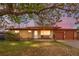 Charming brick ranch with a cozy front porch, mature trees, and attached two-car garage at 258 S 14Th Ave, Brighton, CO 80601