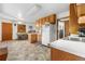Eat-in kitchen with wood cabinets, white appliances, and ample counter space at 258 S 14Th Ave, Brighton, CO 80601
