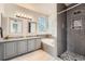 Stylish bathroom featuring a double vanity, a separate shower, and a luxurious soaking tub for relaxation at 4037 S Odessa Cir, Aurora, CO 80013
