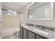 Bright bathroom with a double sink vanity, tiled floors, and a shower/tub combo for convenience at 4037 S Odessa Cir, Aurora, CO 80013