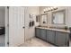 Modern bathroom with a double sink vanity, granite countertops, and tasteful decor for a spa-like experience at 4037 S Odessa Cir, Aurora, CO 80013