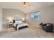 Cozy bedroom with a calming gray palette, with a large window for natural light, and soft carpet flooring at 4037 S Odessa Cir, Aurora, CO 80013