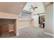 Cozy carpeted bedroom with a ceiling fan and an ensuite bathroom with sliding barn door at 4037 S Odessa Cir, Aurora, CO 80013