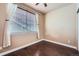 Inviting bedroom with hardwood floors and a large window providing natural light, creating a serene space at 4037 S Odessa Cir, Aurora, CO 80013