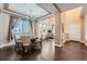 Elegant dining area with hardwood floors, coffered ceilings, chandelier, and modern furnishings at 4037 S Odessa Cir, Aurora, CO 80013