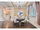 Dining area with decorative lighting, neutral wall colors, dark hardwood floors and staircase at 4037 S Odessa Cir, Aurora, CO 80013