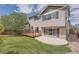 Exterior view of a two-story home with a spacious backyard, wood deck, and concrete patio at 4037 S Odessa Cir, Aurora, CO 80013