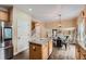Bright kitchen featuring a kitchen island, stainless steel appliances, adjacent to casual dining area at 4037 S Odessa Cir, Aurora, CO 80013