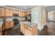 Well-lit kitchen featuring stainless steel appliances, an island, and white tiled backsplash at 4037 S Odessa Cir, Aurora, CO 80013