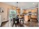 Bright and airy eat-in kitchen with stainless steel appliances, wood cabinets, and access to outdoor deck at 4037 S Odessa Cir, Aurora, CO 80013