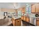 Open kitchen featuring stainless steel appliances, granite countertops, and an island with wood cabinets at 4037 S Odessa Cir, Aurora, CO 80013