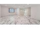 Open living room area featuring sleek marble floors, recessed lighting, and bright windows at 4037 S Odessa Cir, Aurora, CO 80013