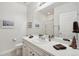 Bathroom with a vanity, sink, mirror, and a shower featuring neutral decor at 5029 Silver Hare Ct, Castle Rock, CO 80104