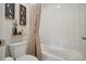 Clean bathroom featuring a bathtub and shower combination next to a toilet and decorative wall art at 5029 Silver Hare Ct, Castle Rock, CO 80104