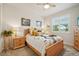 Well-lit bedroom with a light wood frame bed, with night stands on each side, and a ceiling fan at 5029 Silver Hare Ct, Castle Rock, CO 80104