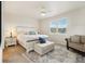 A bright bedroom features a ceiling fan, a large window, and is furnished with modern furniture at 5029 Silver Hare Ct, Castle Rock, CO 80104