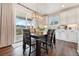 Bright dining area featuring modern lighting, wood floors, and sliding glass doors to the outside at 5029 Silver Hare Ct, Castle Rock, CO 80104