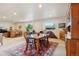 Open dining room featuring a wooden table with chairs set on a stylish patterned rug and bright lighting at 5029 Silver Hare Ct, Castle Rock, CO 80104