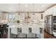 Bright kitchen showcasing white cabinets, a center island, and stainless steel appliances at 5029 Silver Hare Ct, Castle Rock, CO 80104