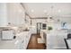 Spacious kitchen with white cabinetry, stainless steel appliances, and breakfast bar seating at 5029 Silver Hare Ct, Castle Rock, CO 80104
