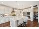 Well-lit kitchen with white cabinetry, center island, and convenient pantry access at 5029 Silver Hare Ct, Castle Rock, CO 80104