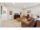 Spacious living room featuring a comfortable brown leather sofa, coffee table, and stylish decor at 5029 Silver Hare Ct, Castle Rock, CO 80104