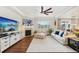 Spacious living room with large windows, fireplace, and comfortable seating area at 5029 Silver Hare Ct, Castle Rock, CO 80104