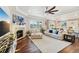 Open-concept living area with hardwood floors, fireplace, and seamless kitchen access at 5029 Silver Hare Ct, Castle Rock, CO 80104