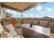 Covered patio with outdoor seating, a grill, and scenic views at 5029 Silver Hare Ct, Castle Rock, CO 80104