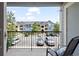 Balcony view overlooking the community buildings and parking area under a partly cloudy sky at 4451 S Ammons St # 4-203, Littleton, CO 80123
