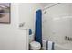 Bathroom featuring a tub and shower combination with a blue shower curtain, and white walls at 4451 S Ammons St # 4-203, Littleton, CO 80123