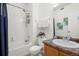 Bathroom featuring a shower and tub combo, commode and vanity at 4451 S Ammons St # 4-203, Littleton, CO 80123