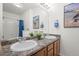 Bathroom showcasing double sinks, granite counters, and framed mirror at 4451 S Ammons St # 4-203, Littleton, CO 80123