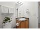 Cozy bathroom featuring a wooden vanity, patterned countertop, and ample lighting at 4451 S Ammons St # 4-203, Littleton, CO 80123